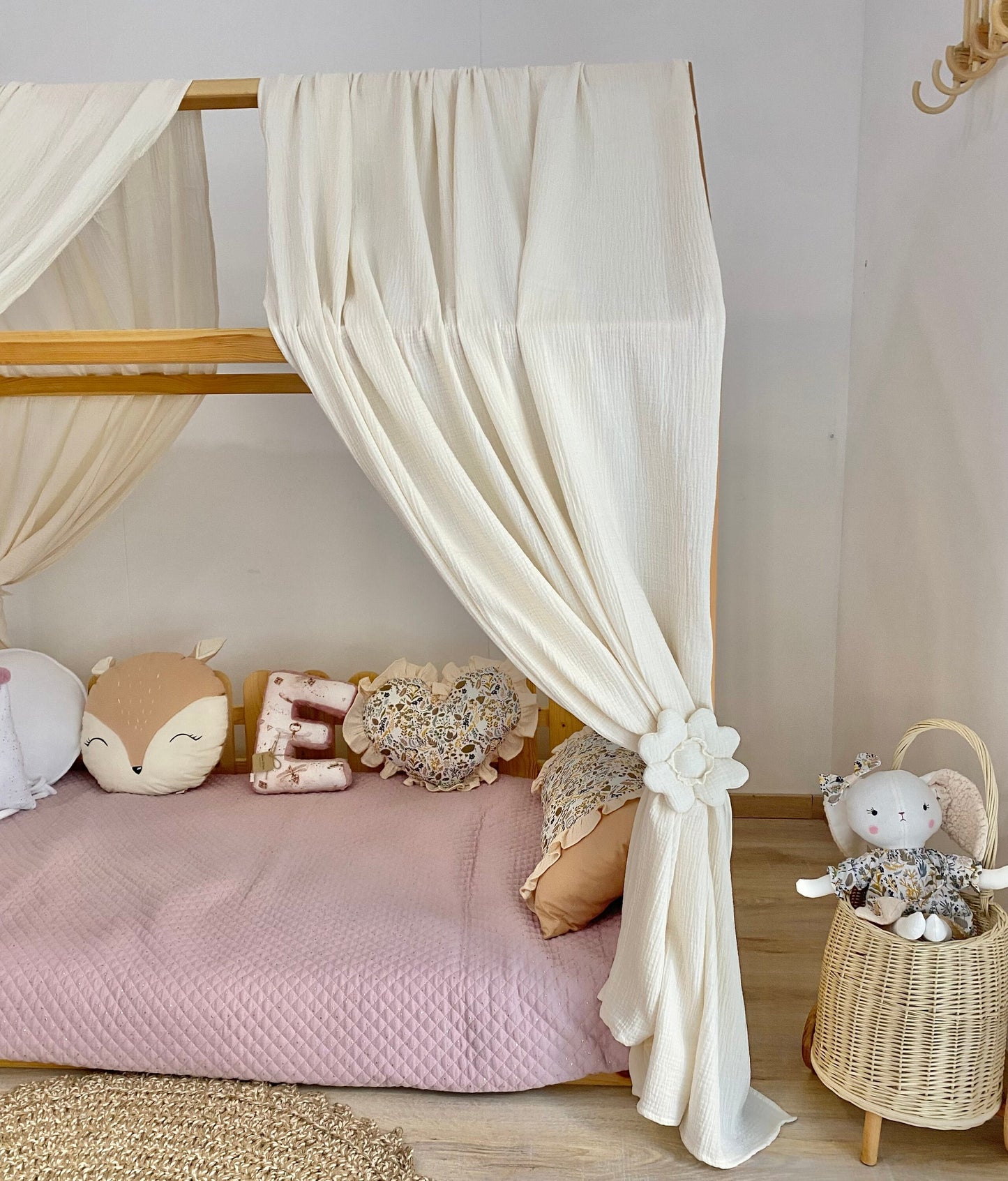 Cream canopy draped over Montessori floor bed