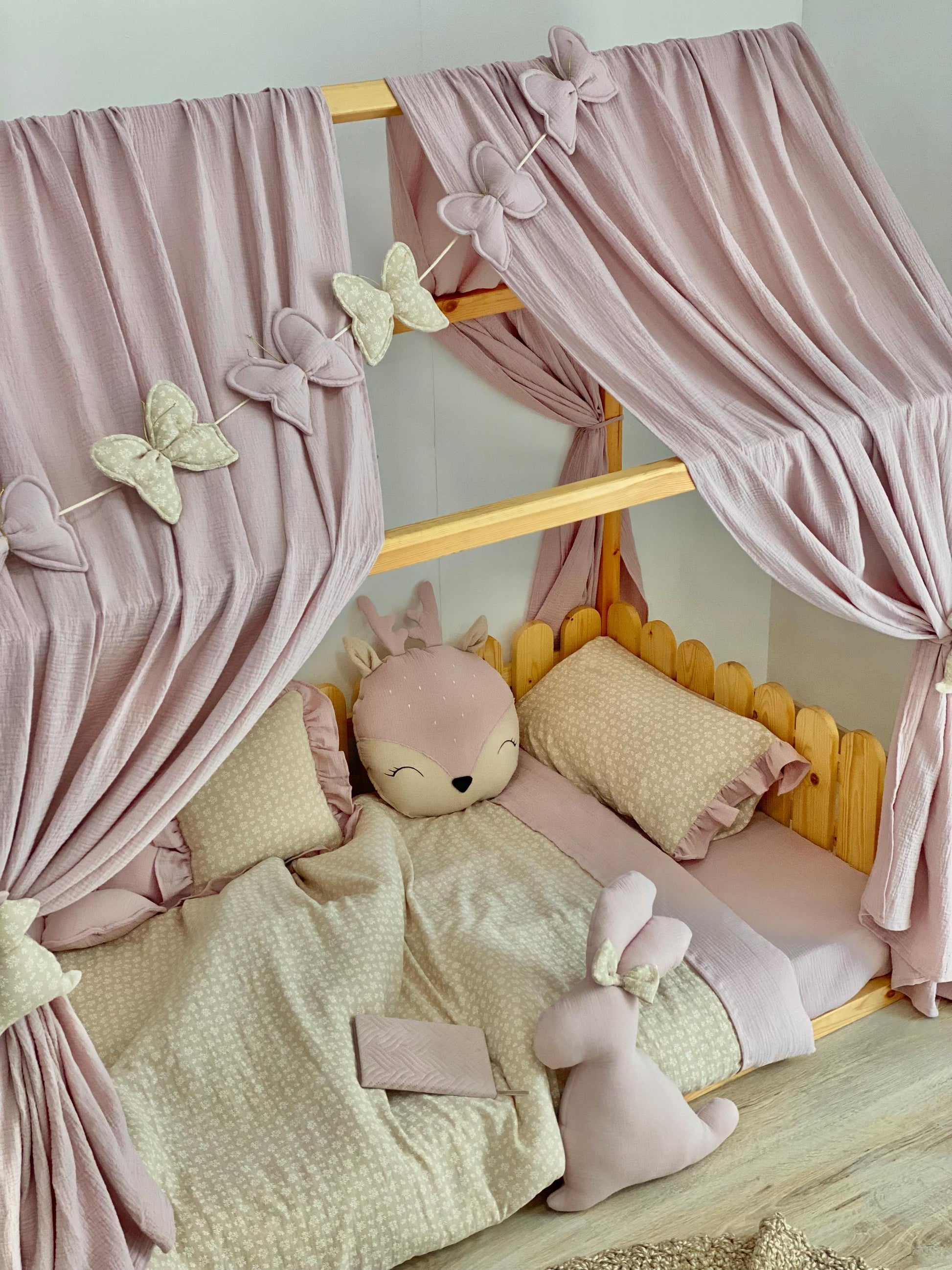 Handmade cotton muslin toddler duvet cover set with animal print styling on wooden Montessori kids bed