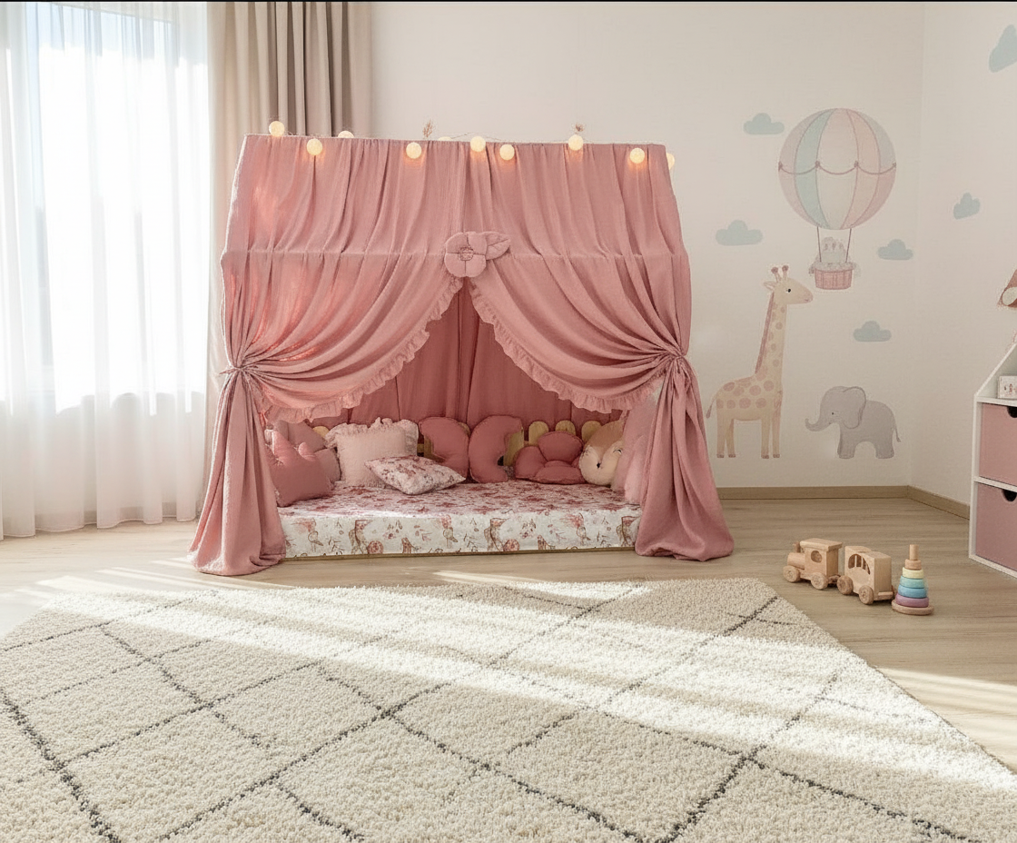 Dusty rose canopy with ruffles over Montessori floor bed