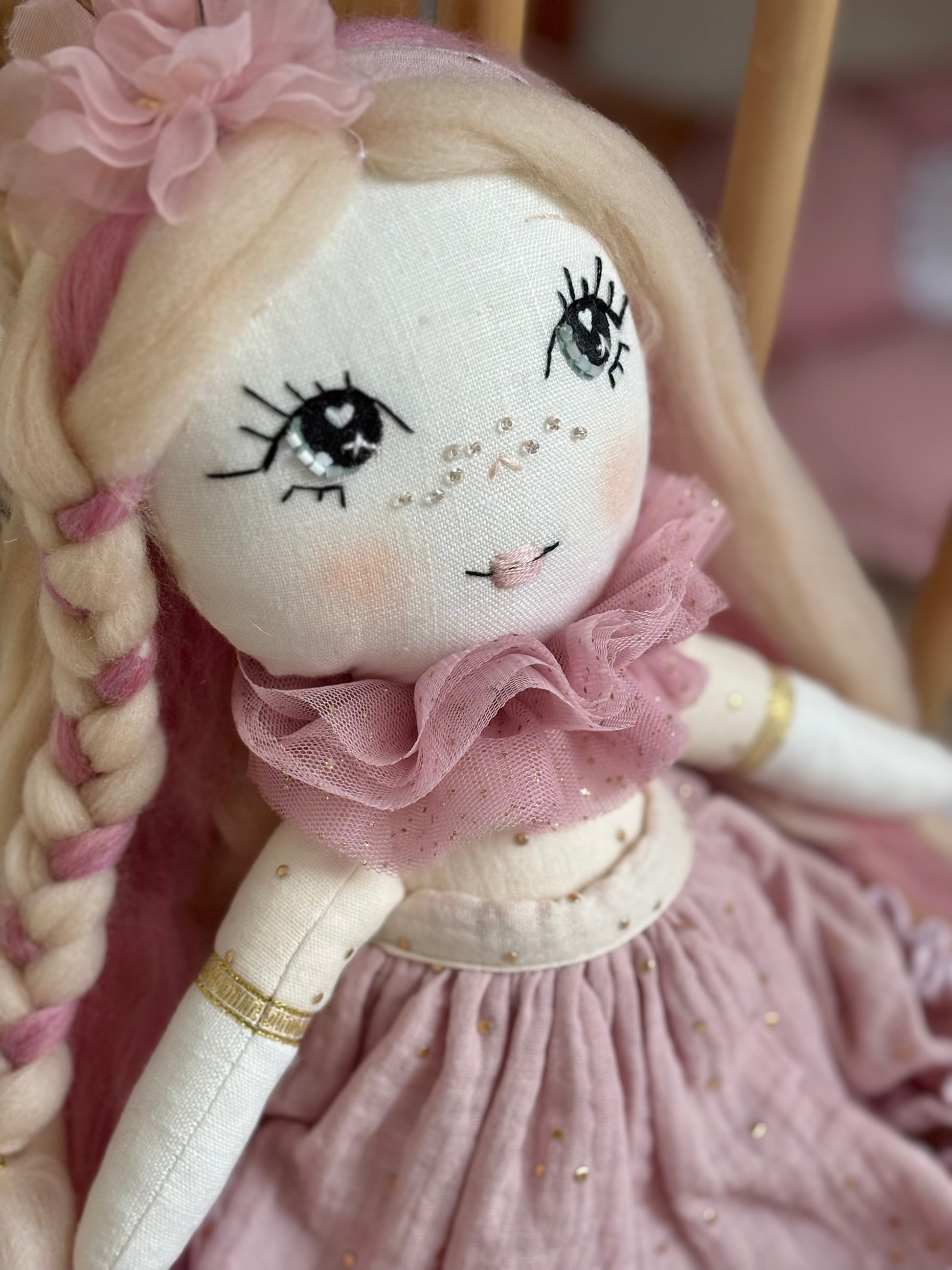 Handmade cloth doll in blush pink dress with hand-stitched face and long hair, heirloom fabric doll for nursery décor and baby gift