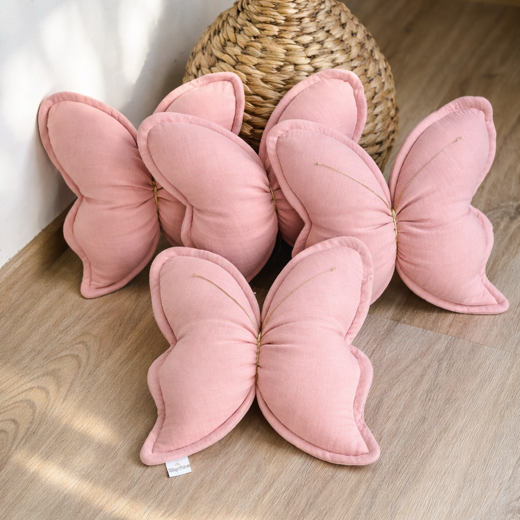 Handmade pink butterfly pillow for nursery made from soft cotton muslin fabric