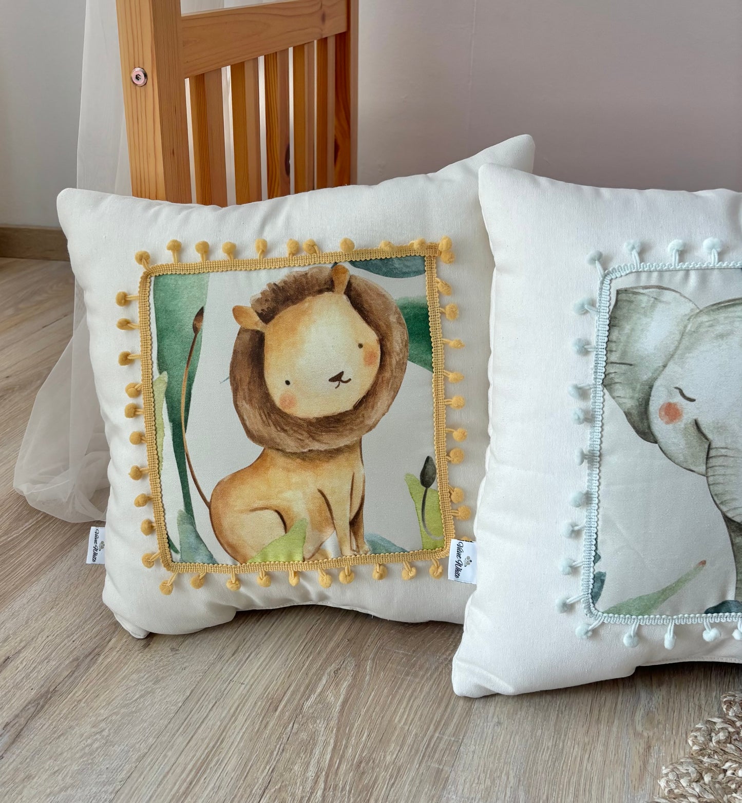 Safari nursery pillow set with lion, elephant, giraffe and zebra design in neutral kids room