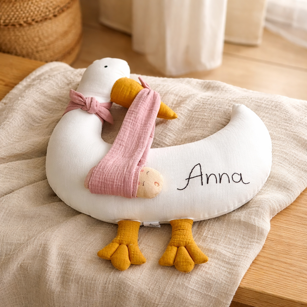 Personalized stork baby pillow with embroidered name in neutral nursery setting